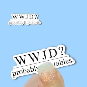 May include: Two white stickers with black text on a light blue background. The stickers read "WWJD?" above the phrase "probably flip tables."
