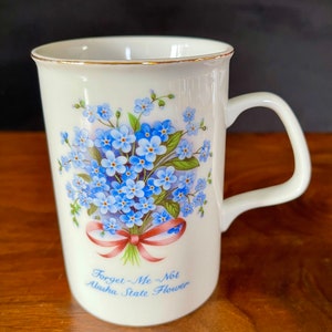 Before 2000 Porcelain Alaska State Flower of For-Get-Me-Not, Pure What w Blue Green Flowers Pink Ribbon, Exc. VTG Cond. Some Wear to Gold