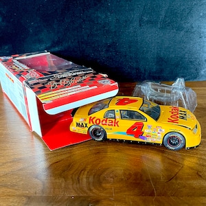 1998 ボビー ハミルトン、シグネチャー ドライバー シリーズ レーシング チャンピオン、NASCAR 50 周年記念、ダイキャスト 1:24 スケール、コダック、モンテ カルロ、新品同様