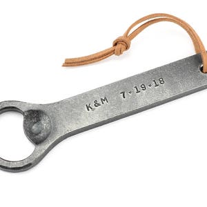 Personalized hand forged Iron bottle opener on a white background.