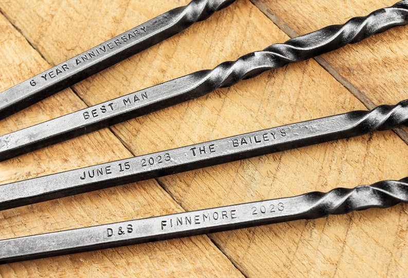 Examples of custom personalization engravings on hand forged steel fire tools.