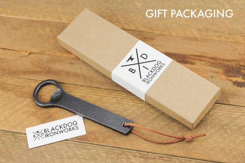 Our gift packaging option which consists of a kraft colored box that is long and rectangular and a white closure, printed with the Black Dog Ironworks logo.