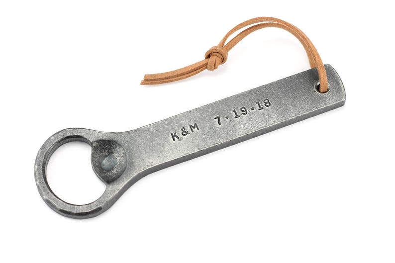Personalized hand forged Iron bottle opener on a white background.