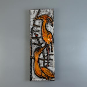 May include: A rectangular wall art piece featuring two stylized orange birds against a white and gray background. The birds are perched on a dark, branch-like structure. The artwork has a textured appearance, with black outlines and accents.