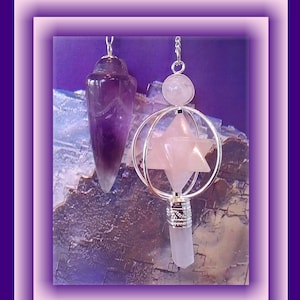 May include: Two crystal pendulums hang against a textured background. One is a purple, teardrop-shaped fluorite pendulum. The other features a rose quartz star within a silver cage, topped with a rose quartz sphere and a clear quartz point.