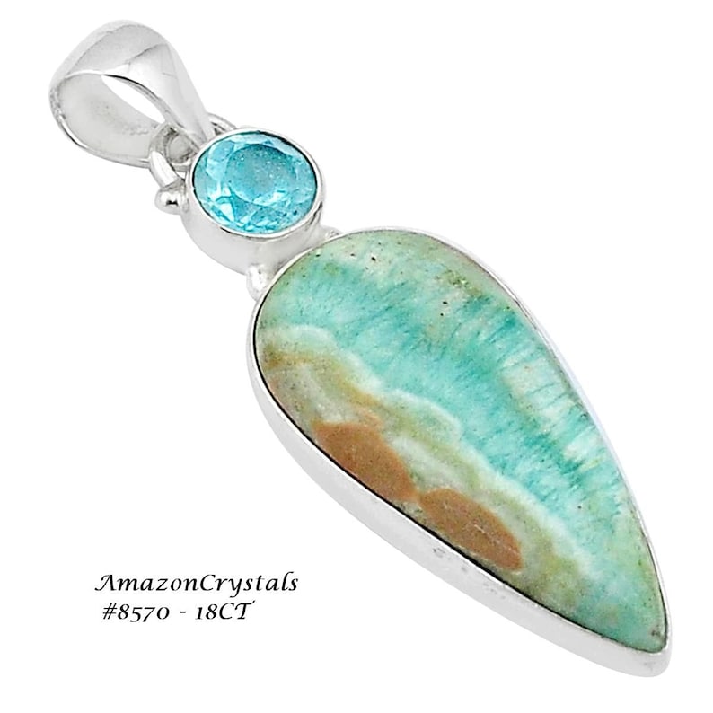 May include: A silver pendant featuring a teardrop-shaped green and brown gemstone, with a smaller round blue gemstone. The pendant is labelled "AmazonCrystals #8570 - 18CT".