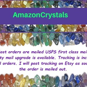 May include: A colorful assortment of crystals and gemstones, with the text "AmazonCrystals" at the top. The text below reads: "Most orders are mailed USPS first class mail. Priority mail upgrade is available. Tracking is included on all orders. I will post tracking on Etsy as soon as the order is mailed out."