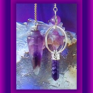 May include: Two amethyst crystal pendulums on gold chains. One pendulum is a point and the other is a star shape.