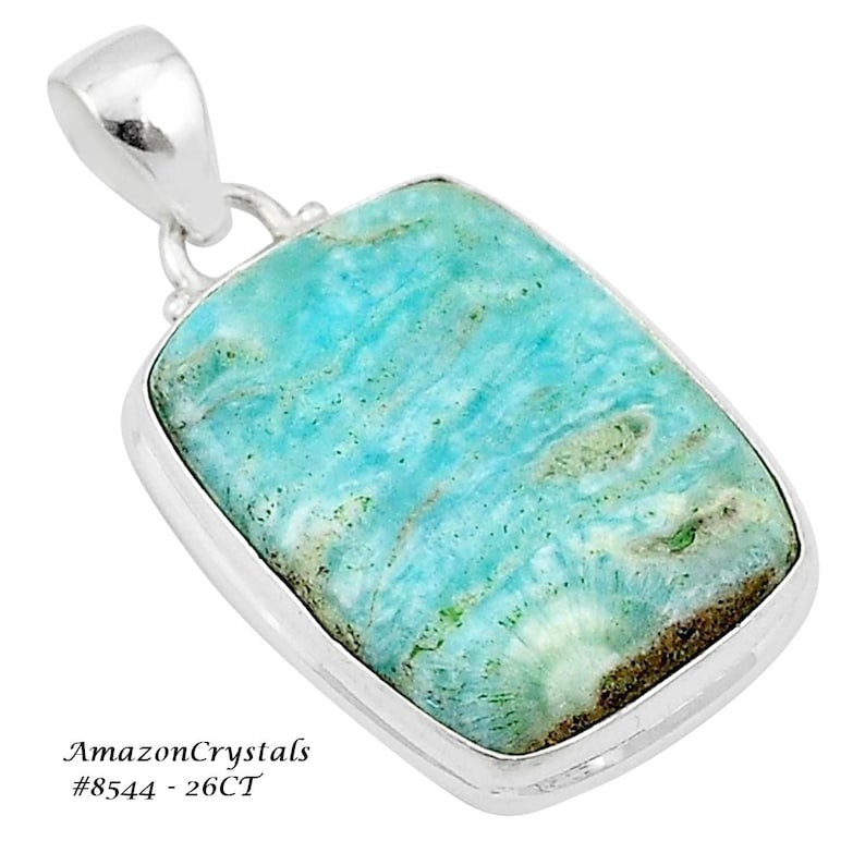 May include: A silver pendant featuring a light blue and green gemstone. The gemstone has a swirling pattern and is set in a silver bezel. The pendant is 26 carats.