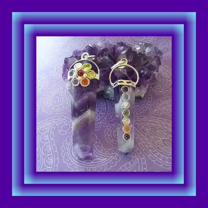 May include: Two amethyst crystal pendants with silver settings. One pendant has a cluster of seven colorful gemstones, while the other has a row of seven gemstones in different colors.