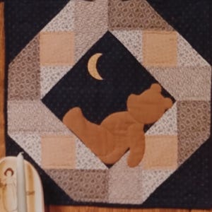 May include: A vintage Primitive Folk Art Collection pattern titled "Lonely Teddy Bear" with a quilt design. The quilt features a brown teddy bear under a crescent moon. The pattern is 18 inches in size and includes the text "Wild Goose Chase".