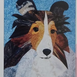 May include: A pattern booklet titled Picture Quilts by Sharon Malec featuring a Sheltie dog illustration on the cover. The cover includes the text Malec Designs, Over 50 Patterns Available, and the website address www.malec-designs.com.