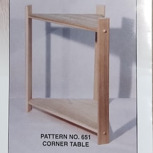 May include: A woodworking pattern for a corner table. The image shows a partially constructed wooden corner table with a triangular top and two shelves. The text reads "Simple & Easy Do-It-Yourself Patterns".