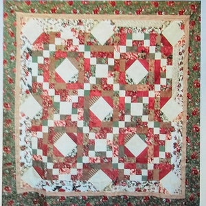 May include: A quilt pattern titled "Diamond Party" by Cozy Strip Club. The design features a patchwork of red, white, and green floral and geometric patterns. The finished quilt size is 70" x 70".