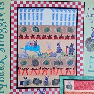 May include: A book cover titled "Cale's Garden" featuring a quilt design with bunnies, carrots, and a blue wheelbarrow. The cover includes the text "Storybook Snugglers" and "Bonus Quilt - Alivia's Bunnies!"