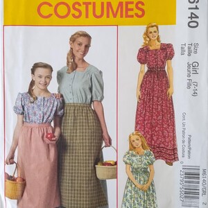 May include: McCall's Costumes sewing pattern M6140 for girls sizes 7-14. The envelope features illustrations of long dresses with puff sleeves and square necklines in floral and plaid fabrics, with some designs including aprons and woven baskets.