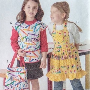 May include: Simplicity sewing pattern 2295 features aprons, tote bags, and accessories for girls. The pattern includes various apron designs with ruffle details and coordinating tote bags. The image shows children modeling the finished products.
