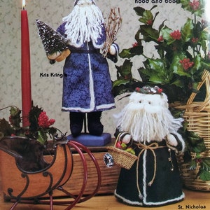 May include: Image of a pattern for making Old Time Santas. The image shows two Santa figures, one tall and one short, with long white beards and traditional outfits. The text reads "Kris Kringle" and "St. Nicholas".