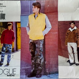 May include: Vogue Men's pattern 2451 featuring three different outfits. The outfits include a red zip-up jacket with camouflage pants, a yellow vest with camouflage pants, and a brown jacket with white pants. The pattern size is 38-40-42.