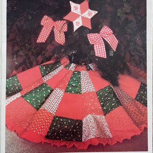 May include: A patchwork tree skirt pattern featuring red, green, and white floral and gingham fabrics. The design includes a star and two bows, with text reading Patchwork Tree Skirt, Full Size Pattern, Complete Instructions, and Quilter's Heaven.