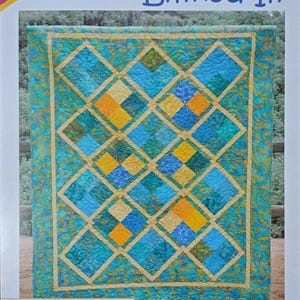 May include: A quilt pattern titled "Linked In" by Cozy Quilt Designs. The quilt design features a geometric pattern with blue, teal, and yellow squares and diamonds. The pattern includes baby, throw, twin, queen, and king sizes.