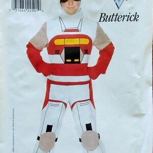 May include: A costume pattern for a VR Troopers Kaitlin Star outfit. The pattern features a white and red jumpsuit with matching gloves, a helmet, and knee pads. The package includes the text "4177 KAITLIN STAR".