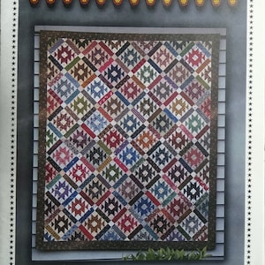 May include: A quilt pattern titled "Rocky Mountain Summer" by Carole Charles. The quilt design features a geometric pattern in various colors, including red, blue, green, and brown. The finished size is 57" x 68". The top of the image reads "Primitive Gatherings".