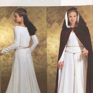 May include: A sewing pattern by Butterick, B4377, featuring a medieval-style dress with long sleeves and a fitted bodice. The pattern includes a hooded cape. The dress is white, and the cape is a deep burgundy color. The pattern size is AA (6-8-10-12).