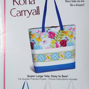 May include: A tote bag sewing pattern titled "Kona Carryall" by Pink Sand Beach Designs. The bag features a floral print with blue, pink, and yellow flowers, a white stripe, and a blue base. The pattern includes picture instructions.