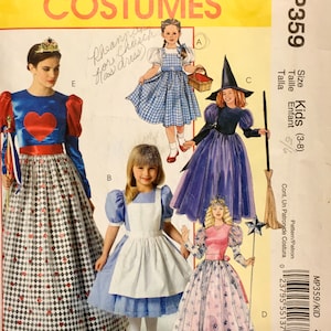 May include: McCall's Costumes pattern MP359 for kids aged 3-8. The image shows illustrations of various costume designs, including a princess, a witch, Alice in Wonderland, and Dorothy from The Wizard of Oz.