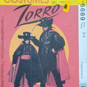 May include: McCall's Costumes pattern for a Zorro costume. The image shows two figures in black Zorro outfits with capes, hats, and swords. The pattern includes sizes 2 and 4. The text on the package reads "...the legend continues..."