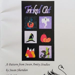 May include: A sewing pattern booklet titled Tricked Out from Swan Amity Studios by Swan Sheridan. The cover features a black rectangular graphic with six Halloween-themed squares: a cauldron, a ghost, a witch hat, pumpkins, candy corn, and a shoe.