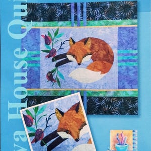 May include: A quilt titled "Testing Instincts" featuring a fox design. The 24" x 24" quilt showcases a fox with orange and white fur, surrounded by birds and foliage. The quilt is made with pieced and appliquéd techniques.