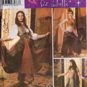May include: Simplicity costume pattern for adults. The pattern features three different costume designs. The costumes include a long skirt, harem pants, and a crop top. The pattern includes the text "Costumes for adults".