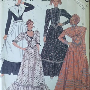 May include: McCall's sewing pattern featuring four vintage dress designs. The designs include long-sleeved dresses with various necklines, skirts, and decorative elements. The pattern includes sizes 10-12-14. The pattern is labeled "2056".