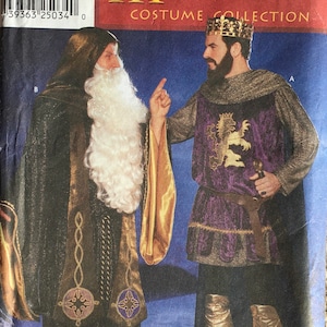 May include: Simplicity Medieval Costume Collection pattern. The image shows two medieval costumes. One is a dark hooded robe with gold accents and a long white beard. The other is a purple and gold tunic with a lion emblem, a crown, and gold boots.