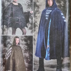 May include: Simplicity S9009 costume pattern. The image shows three costume designs: a spiderweb cape, a hooded cloak, and a dark blue hooded cloak with decorative elements. The pattern includes the text "ONE SIZE".