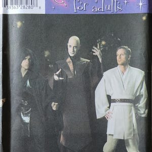 May include: Simplicity costume pattern for adults featuring three character costumes. The cover shows a bald man in a dark robe, a person in a black hooded robe, and a person in a white robe with a brown belt. The text "Costumes for adults" is at the top.