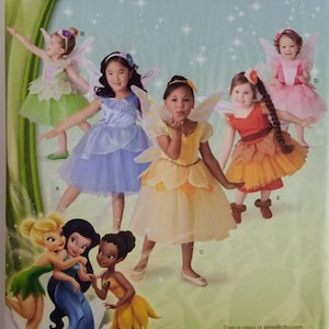 May include: A Disney Fairies home sewing pattern, featuring illustrations of children in fairy costumes. The pattern includes sizes 1/2, 1, 2, and 3. The cover also features Disney Fairies characters.