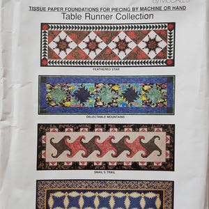 May include: A paper pattern for a table runner collection. The cover features four different table runner designs: Feathered Star, Delectable Mountains, Snail's Trail, and Pineapple. The text "Easy Big Blocks" is at the top.