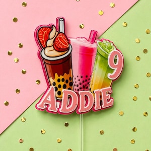 May include: A custom cake topper featuring three bubble tea illustrations with brown, pink, and green gradients. The design includes the name ADDIE in pink block letters and the number 9 in a pink circle. The topper is attached to a clear plastic stick.