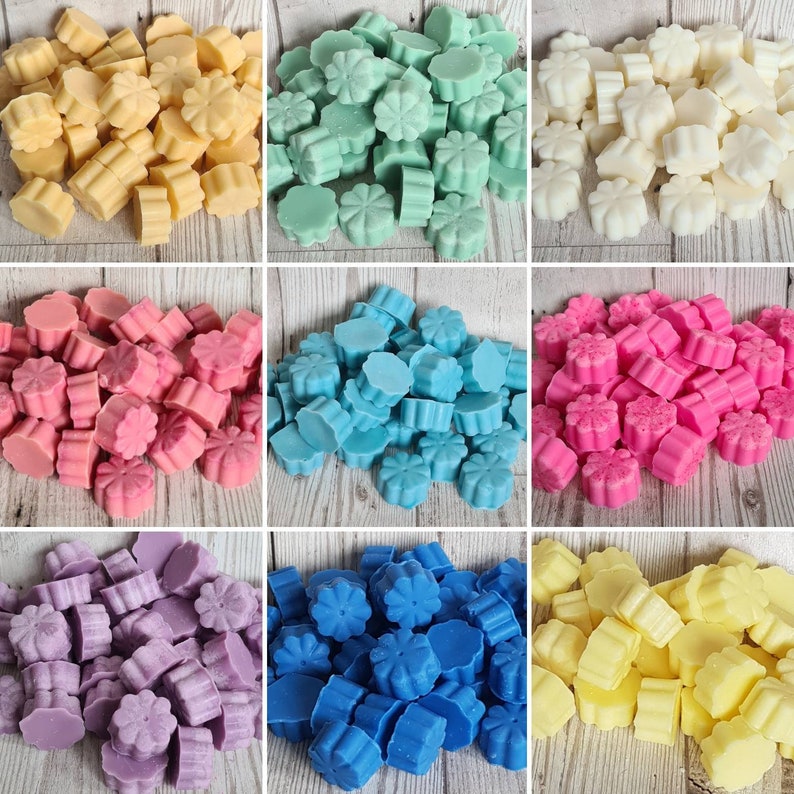 May include: Assortment of wax melts in various colors, including yellow, green, blue, pink, purple, and white. The wax melts are shaped like flowers and are arranged in a grid pattern.