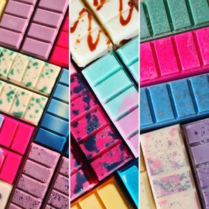 May include: Assortment of colorful wax melts in various patterns and colors, including pink, blue, green, white, and black. The wax melts are arranged in a grid pattern.