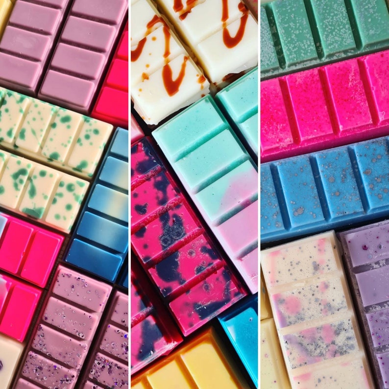 May include: Assortment of colorful wax melts in various patterns and colors, including pink, blue, green, white, and black. The wax melts are arranged in a grid pattern.