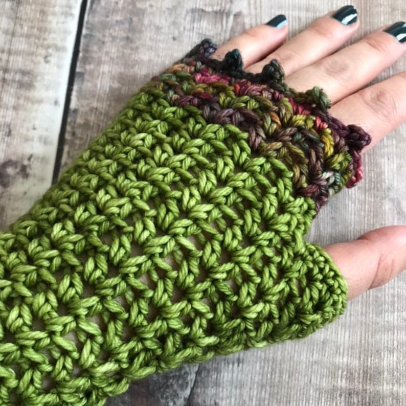May include: Green crochet fingerless gloves with a colorful crocheted cuff.