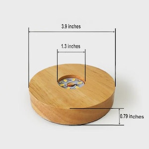 May include: A round wooden LED light base, 3.9 inches in diameter, with a 1.3-inch recessed center. The base is 0.79 inches thick and includes a power cord. Additional images show the base with the cord and a close-up of the LED lights.