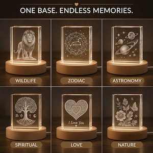 May include: A collection of illuminated crystal blocks with various etched designs, including a lion, zodiac symbols, planets, a tree, a heart with "I Love You," and flowers. Each block sits on a wooden base, with the text "ONE BASE. ENDLESS MEMORIES."
