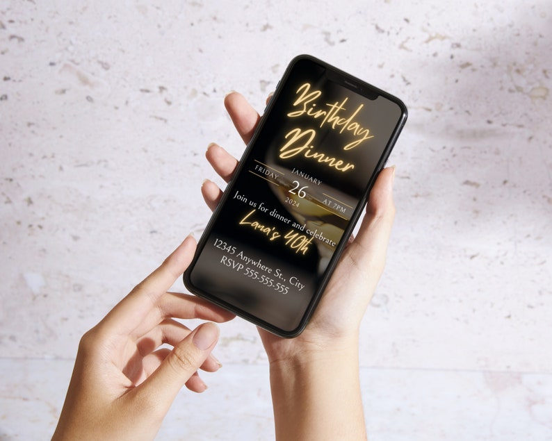 May include: A black smartphone screen displaying a birthday dinner invitation with gold text. The invitation reads "Birthday Dinner", "Friday, January 26, 2024 at 7 PM", "Join us for dinner and celebrate Lana's 40th", "12345 Anywhere St., City", and "RSVP 555-555-555".