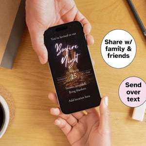May include: A smartphone displaying a Bonfire Night invitation. The invitation includes the text "You're Invited to our Bonfire Night" with the date September 25th at 7 PM. The invitation also mentions s'mores and blankets. The phone is held by hands.