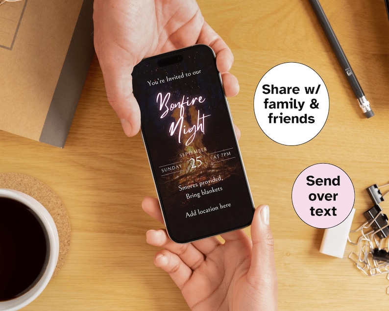 May include: A smartphone displaying a Bonfire Night invitation. The invitation includes the text "You're Invited to our Bonfire Night" with the date September 25th at 7 PM. The invitation also mentions s'mores and blankets. The phone is held by hands.